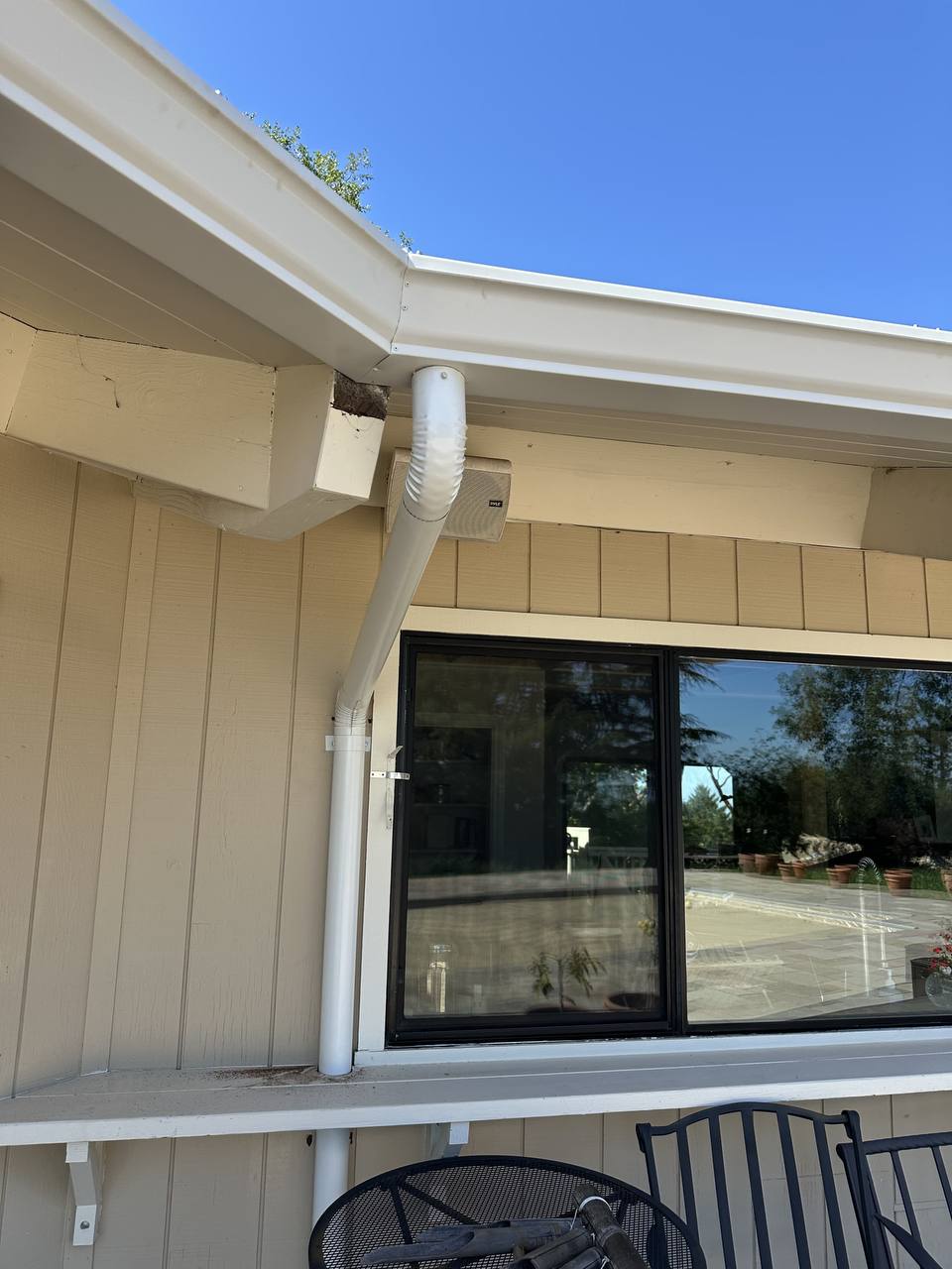 Close-up detail of a precision-fitted downspout elbow and gutter bracket