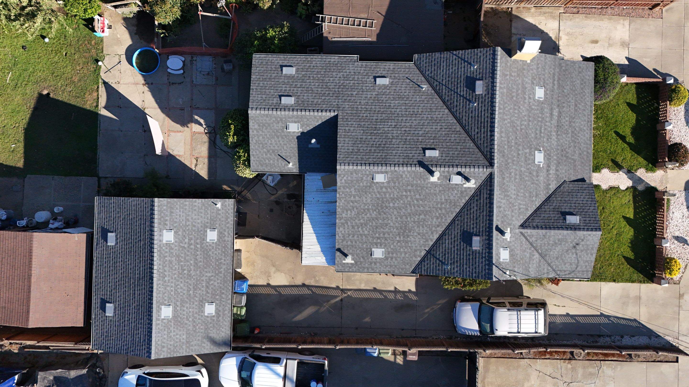 Aerial drone view of a multi-unit roof complex inspected for storm damage during an insurance claim