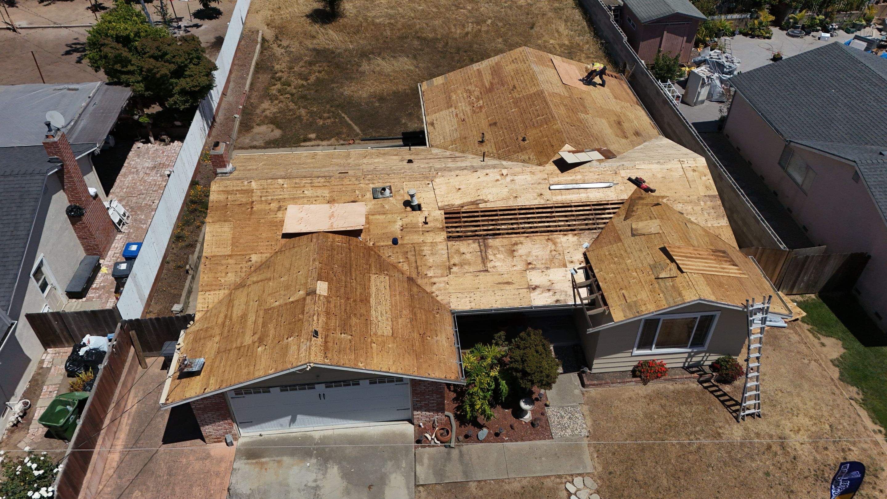 Roof tear-off and sheathing repair in progress