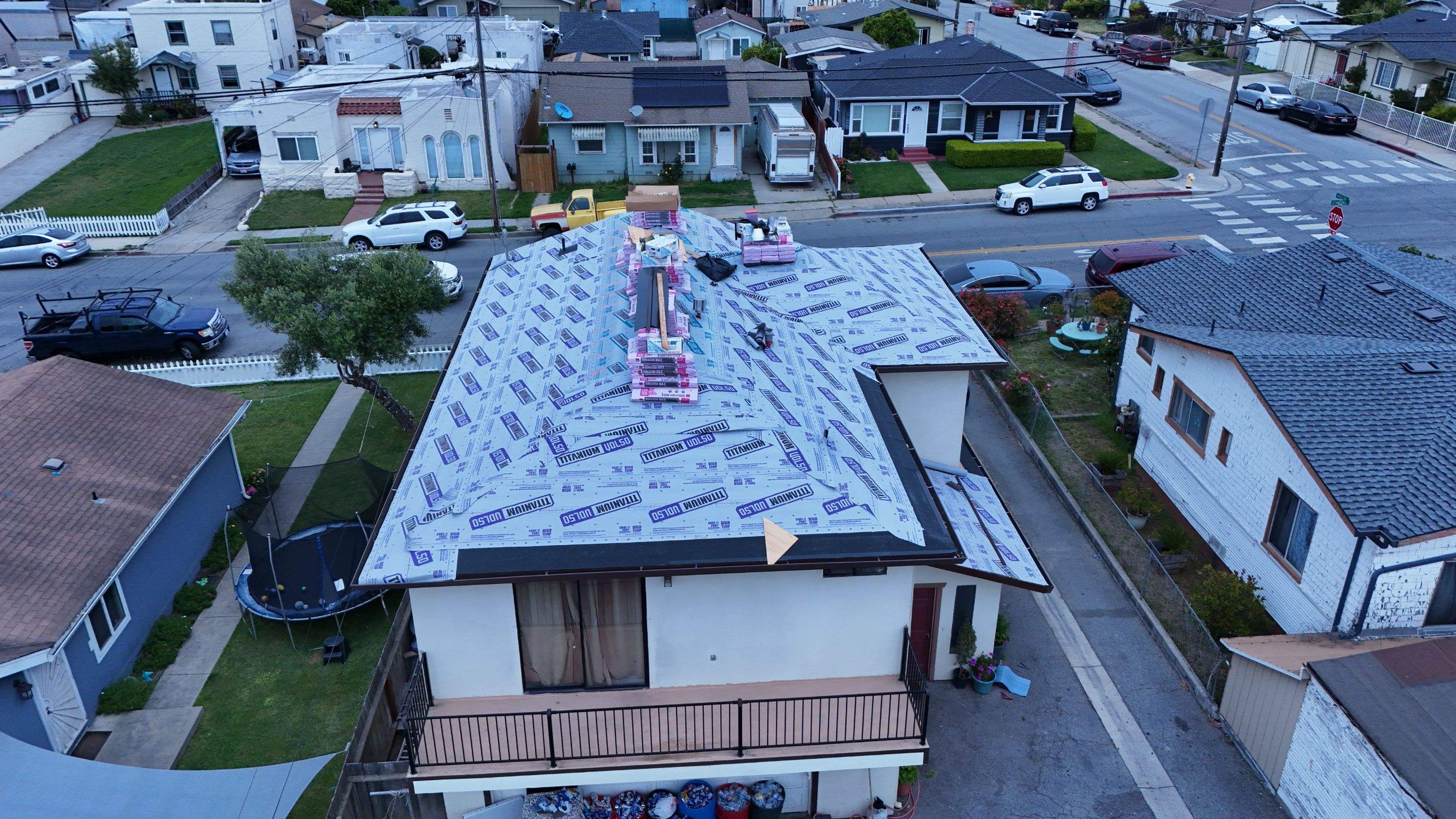 Aerial view of new underlayment installation on a residential roof